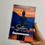 Cover of the book 'Satori' by Dr. Nimit Oza, featuring a meditating Buddha against a sunset sky and water reflection, subtitle visible.